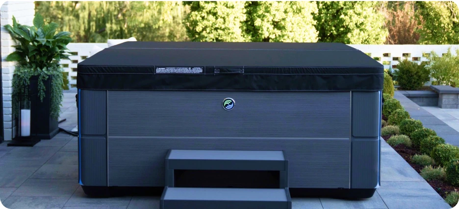 Hot Spring Highlife Alpine White Aria on a patio, topped with a charcoal cover.