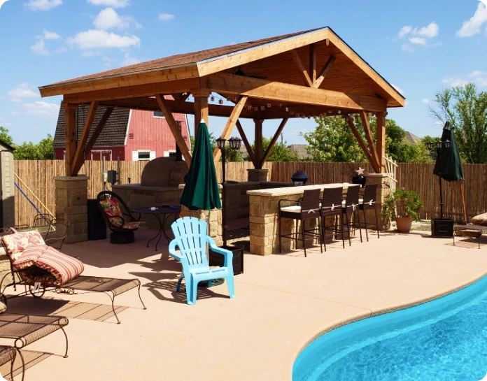 Gazebo with a dining area near a pool, surrounded by a relaxation zone.