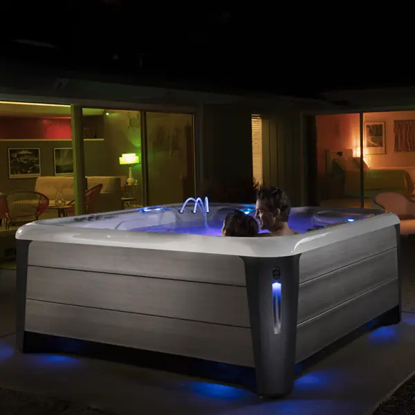 Couple enjoying a HotSpring Highlife Hot Tub at night.